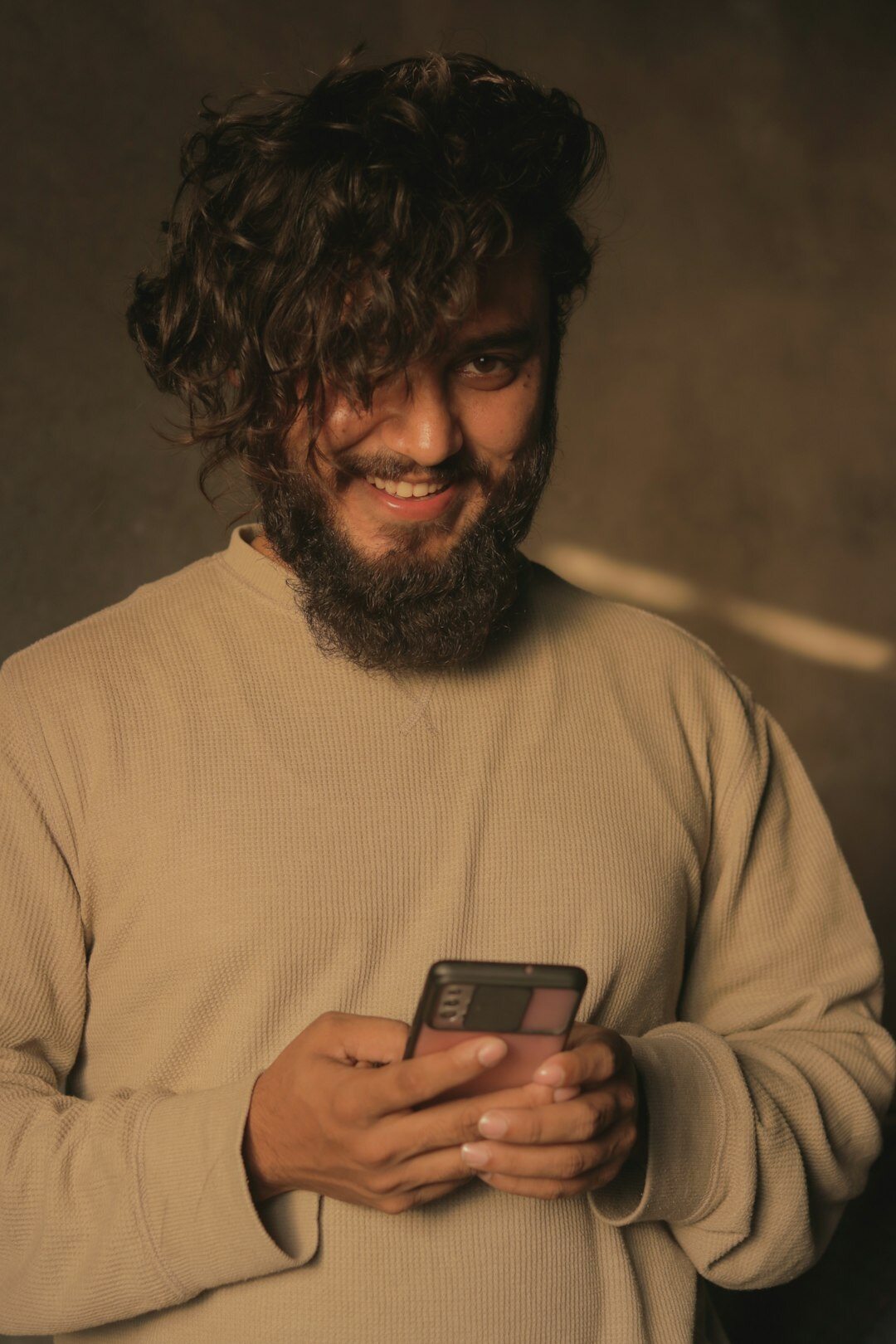 Studio portrait of an Italian-Swiss man in his thirties with dark curly hair, data journalist